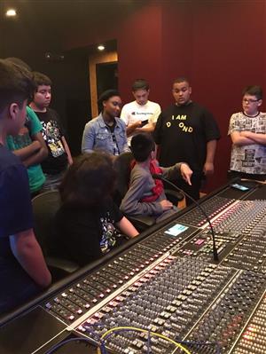 Band students standing around a recording console 